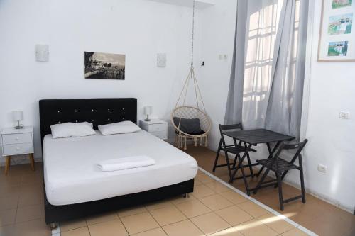 a bedroom with a bed and a table and chairs at Domos Tiberias דומוס טבריה in Tiberias