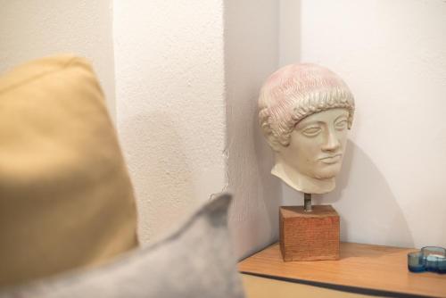 a statue of a head sitting on a shelf at Athenian Niche in Plaka Villa by Athenian Homes in Athens