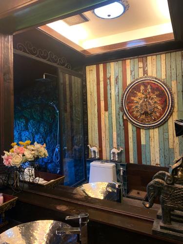 a bathroom with a mirror and a sink and a toilet at Bantunglom Resort in Mae Rim