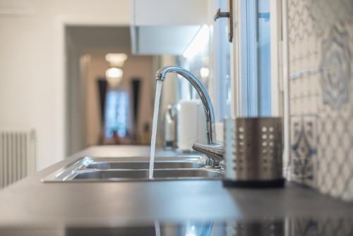 a kitchen sink with a faucet on a counter at Athenian Niche in Plaka Villa by Athenian Homes in Athens