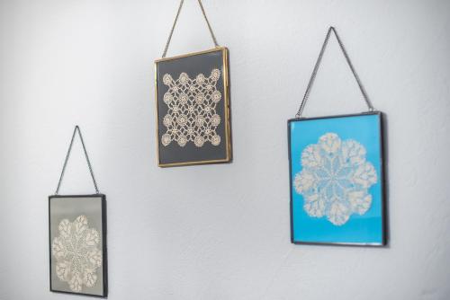 four framed snowflakes are hanging on a wall at Athenian Niche in Plaka Villa by Athenian Homes in Athens