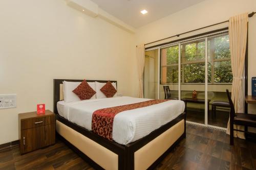Ένα ή περισσότερα κρεβάτια σε δωμάτιο στο Super Hotel O Divine Residency Near Phoenix Marketcity
