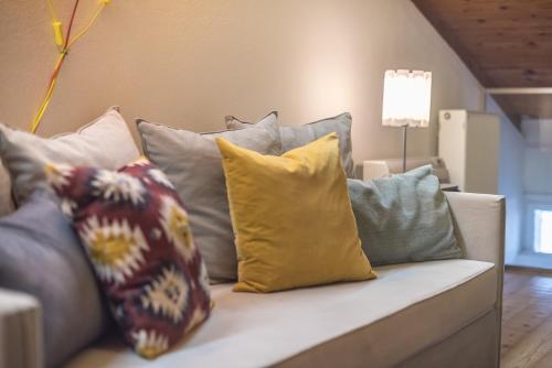 a couch with many pillows sitting on it at Athenian Niche in Plaka Villa by Athenian Homes in Athens