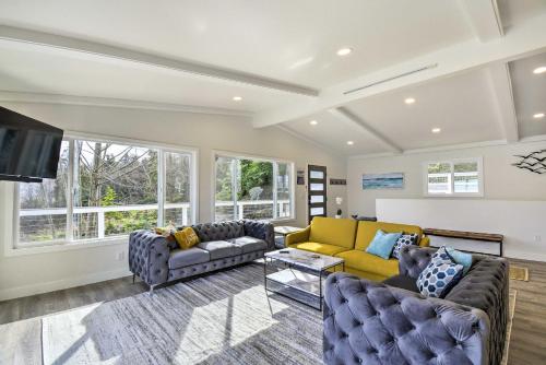 a living room with two couches and a tv at Waterfront Kingston Getaway on Puget Sound! in Kingston