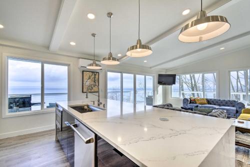 a kitchen with a large island and a living room at Waterfront Kingston Getaway on Puget Sound! in Kingston