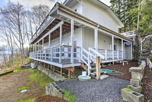 a house with a large porch on the side of it at Waterfront Kingston Getaway on Puget Sound! in Kingston