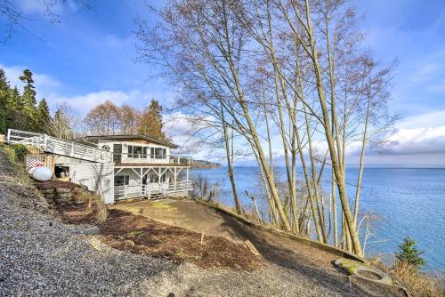 a large house on the shore of a body of water at Waterfront Kingston Getaway on Puget Sound! in Kingston