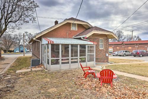 a house with two red chairs and a table at Omaha Vacation Rental about 4 Mi to Downtown in Omaha