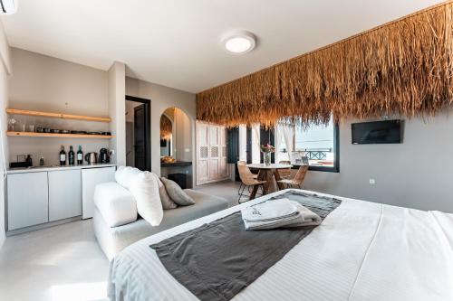a bedroom with a large bed and a kitchen at IfestAu.4 Suites in Fira