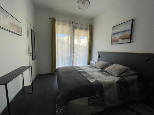 une chambre avec un lit et une fenêtre dans l'établissement Charmant T 2 à deux pas du centre-ville et Mer, à Saint-Palais-sur-Mer