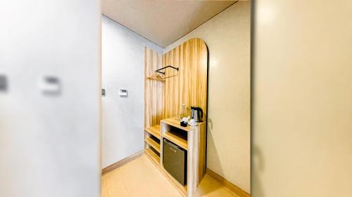 a hallway with a room with a wooden wall at Madison 101 Hotel + Tower in Manila