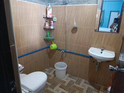 a bathroom with a toilet and a sink at ANNI'S BEACH HOUSE in Lucena