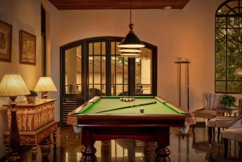 a living room with a pool table and a lamp at Clove Villa in Kandy