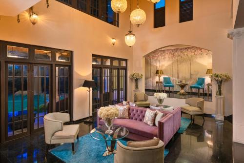 a living room with a purple couch and chairs at Clove Villa in Kandy