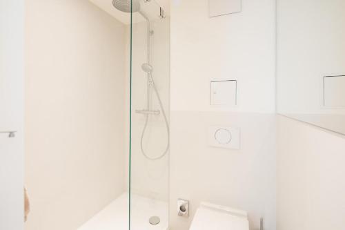 a shower with a glass door in a bathroom at Nordstrandperle Ap E4 in Norderney