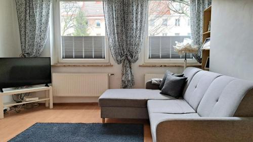 a living room with a couch and a tv at Sea Side Apartment in Gdańsk