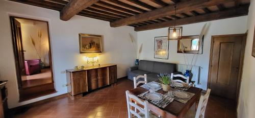 a living room with a table and a couch at Tenuta Colombaio in Casole dʼElsa