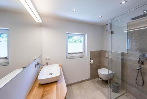 a bathroom with a sink and a shower and a toilet at Ferienwohnungen Veronika Wohnung 1 in Mittenwald