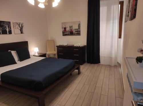 a bedroom with a bed and a dresser in it at CASA ANNIO Holiday Viterbo in Viterbo