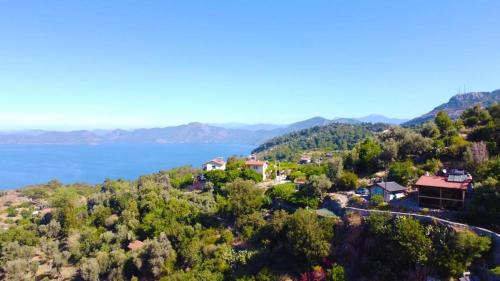 an aerial view of a house on a hill next to the water at SOAP LADY Hotel and More in Mugla