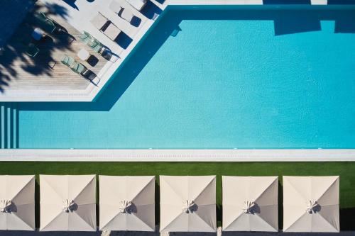 an overhead view of a swimming pool with white at Lena Mare Boutique Hotel in Acharavi