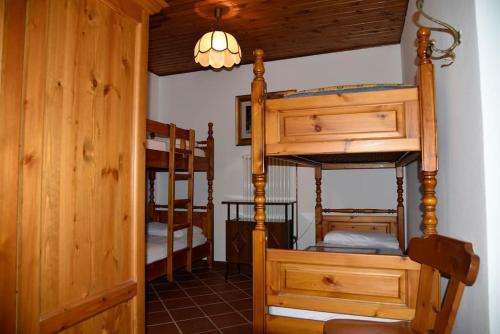 a room with two bunk beds and a room with a hallway at via SOIA 1 in Canale dʼAgordo