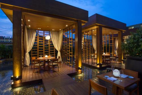 a restaurant with tables and chairs on a deck at City of Dreams - Nobu Hotel Manila in Manila