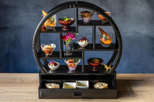 a shelf with bowls and dishes on a table at Urakusatsu TOU in Kusatsu