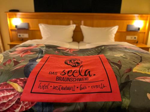 ein Schild auf einem Bett in der Unterkunft Das Seela Braunschweig in Braunschweig