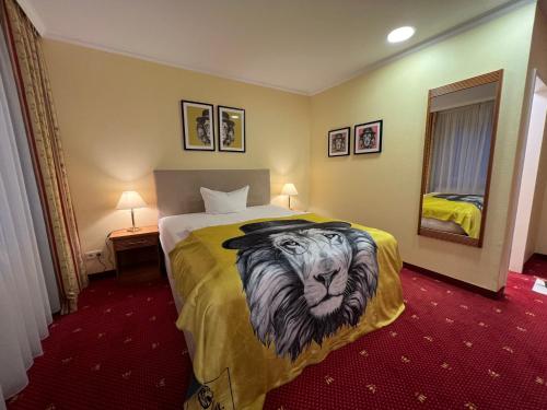 a hotel room with a bed with a lion painted on it at Das Seela Braunschweig in Braunschweig