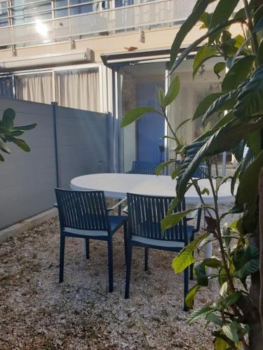 une table, deux chaises, une table et des chaises dans l'établissement Studio 4 personnes avec jardinet à 2 pas des plages 