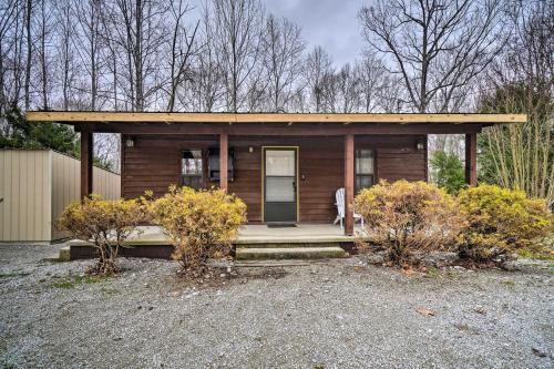 a small wooden house with a porch and a door at Cozy Tennessee Cabin Rental - 1 Mi to Lake in Frogue