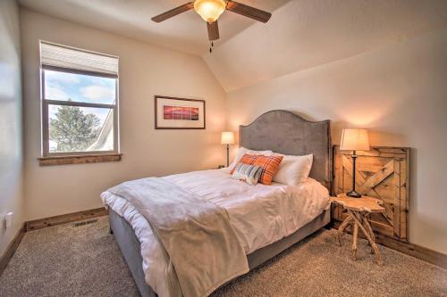 Un dormitorio con una cama con ventilador de techo y una ventana. en McCall Home and Hot Tub about 2 Mi to Payette Lake, en McCall