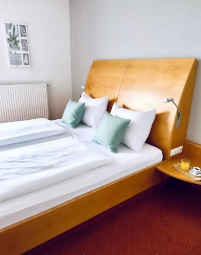 a hotel room with two beds with pillows at Landhotel Stegersbach in Stegersbach