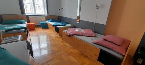 a room with three bunk beds and a window at B3 Hostel Budapest in Budapest