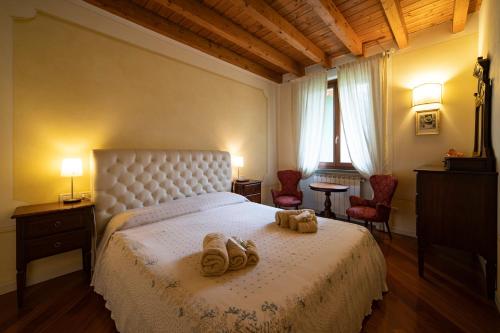 a bedroom with a bed with two slippers on it at ROMANTIC LAKE VIEW HOUSE in Sulzano