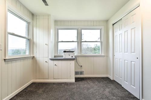 an empty room with two windows and a door at Pennsylvania Vacation Rental Close to Hiking in York