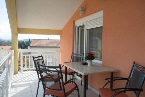 a balcony with a table and chairs on a balcony at Rooms Ivana in Međugorje