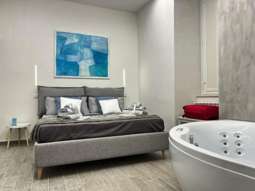 a bedroom with a bed and a bath tub at The Secret Garden in Salerno