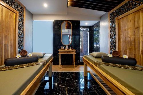 a room with a pool table and a mirror at Swarga Suites Bali Berawa, Marclan Collection in Canggu