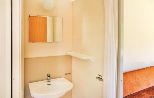 a bathroom with a sink and a mirror at Holiday home Klåvbensvägen Backaryd III in Backaryd