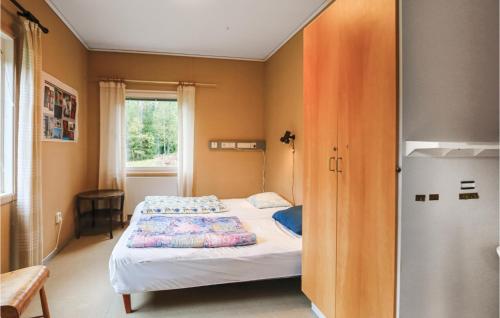 a small bedroom with a bed and a window at Holiday home Klåvbensvägen Backaryd III in Backaryd