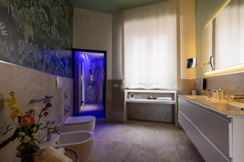 a bathroom with a sink and a purple door at Navona 49 Luxury Suites&Apartment in Rome