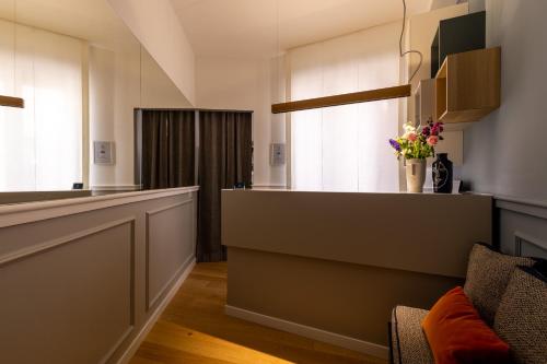 a kitchen with a counter and a couch in a room at Navona 49 Luxury Suites&Apartment in Rome