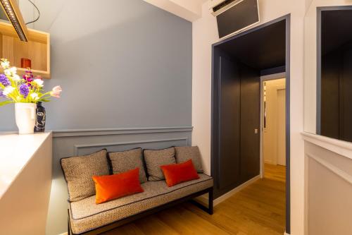 a living room with a couch with orange pillows at Navona 49 Luxury Suites&Apartment in Rome