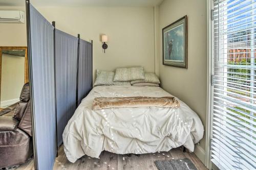 a bedroom with a bed in a room with a window at Pleasant Hill Studio with Pool and Hot Tub Access in Pleasant Hill