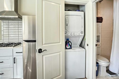 a kitchen with a refrigerator and a washer and dryer at Pleasant Hill Studio with Pool and Hot Tub Access in Pleasant Hill