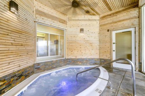 a hot tub in a room with a wooden wall at Lovely Norwich Villa with Shared Amenities! in Norwich