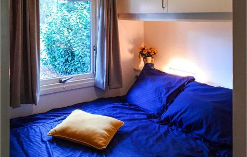 a bed with a pillow on it next to a window at Stunning Home In Vorden With 2 Bedrooms And Wifi in Vorden