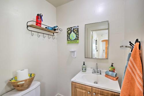 a bathroom with a sink and a mirror at Colorful Long Beach Bungalow with Patio and Grill in Long Beach